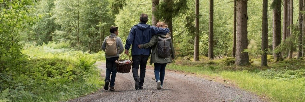 Family walking through a wooded area