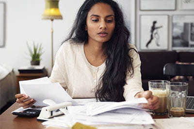 Woman looking at bills