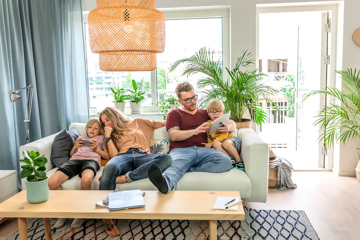 Family relaxing together on a sofa at home.
